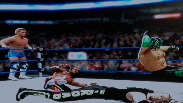 Rey Mysterio and Kofi Kingston pull off a double team move in their match with the Outlaws.